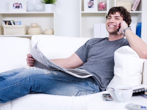 Man with phone and newspaper