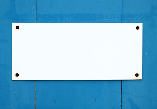 Blank White Sign On A Blue Door.