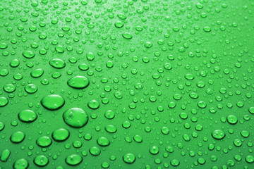 Fototapeta na wymiar Green water drops background with big and small drops