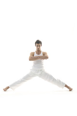 Happy young male in white clothes is jumping