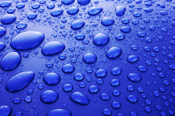 Blue water drops background with big and small drops
