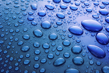 Blue water drops background with big and small drops