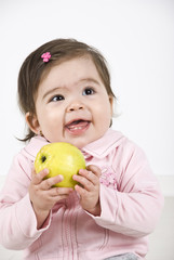 Happy laughing baby with apple