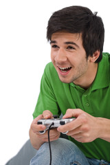 Young happy man playing video game with control pad