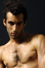 Close up young sensual man on a black