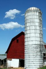 A Red barn and silo against blue sky