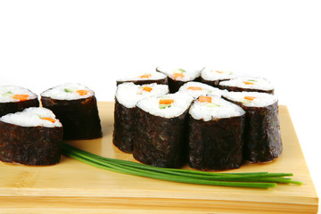 rolls of sushi on wood