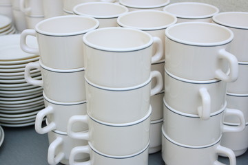 Pile of white clay cups for tea and coffee