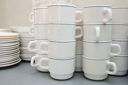 Pile of white clay cups for tea and coffee