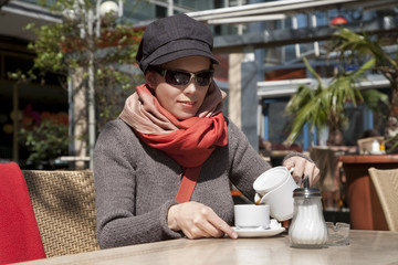 Caucasian young woman enjoying a coffee break