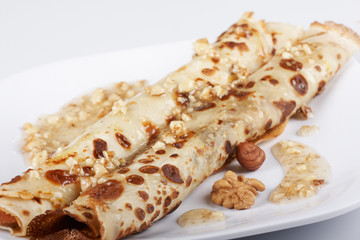 Pancake with honey covered with nuts
