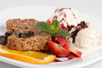 slice of chocolate cake with fruits and ice cream