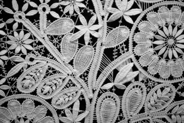 Lace doily on black background, close up. Horizontal format. - obrazy, fototapety, plakaty