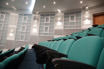Interior of hall for conferences. Rows of chairs for spectators.