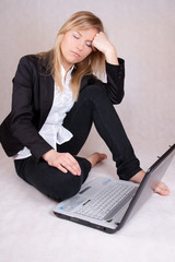 Beautiful business woman sleeping over laptop
