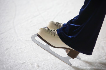 Human feet in fads standing on ice