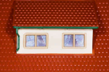 attic on roof of toy plastic house,two windows