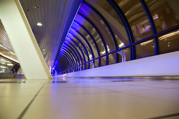 Long corridor with big windows in modern building at night