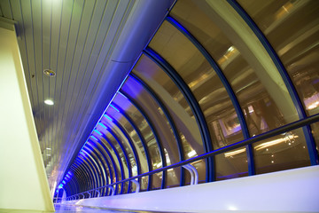 Long corridor with big windows in modern building at night