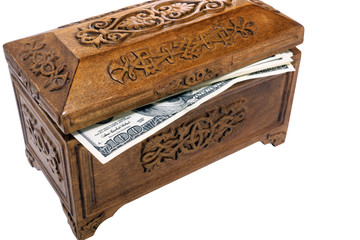 bundle of hundred-dollar bills in a wooden casket