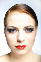 beauty female face with red shiny lips and black eye makeup