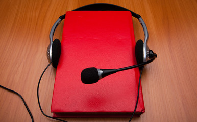 Book is red with headphones