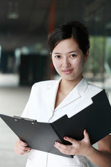 young asian business woman holding with folder