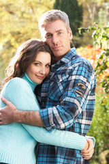 Fototapeta premium Romantic Couple Embracing By Autumn Woodland