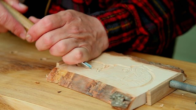 Wood carving artist at work