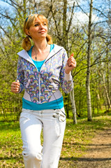 young woman running in forest