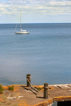 Sail Boat On Lake Superior With Dock In Foreground