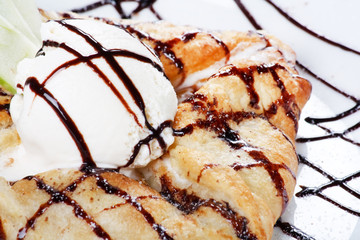 apple cake and ice-cream on a white plate.