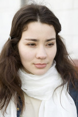 close up portrait of serious woman with white scarf