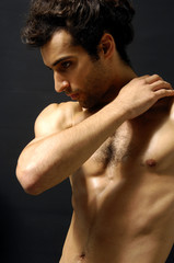 young sensual man on a black background