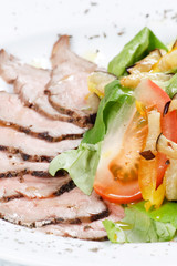 sliced beef with vegetable garnish.