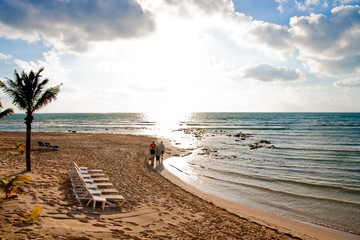 Family Walking Down the Beach Into the sun