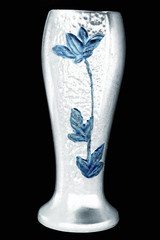 White vase with blue flower embossed on it against black