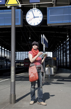 Young woman is waiting for the train