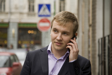 businessmank talking on phone on the street