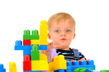 Handsome boy is playing with building blocks