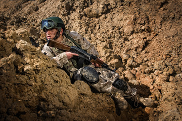 Soldier hiding behind rocks