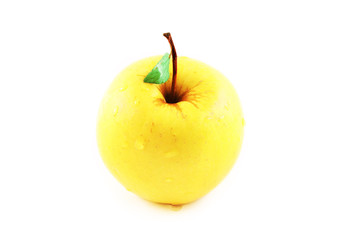 Yellow golden apple with a green leaf