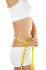 Woman measuring her slim body isolated on white