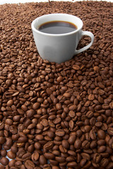 Cup with coffee, costing on coffee grain