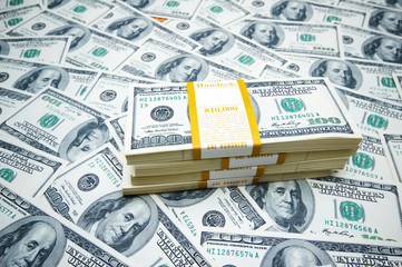 Fototapeta premium Stack of dollars on money background
