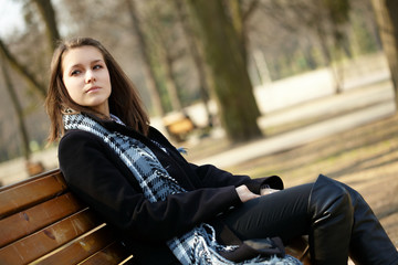 Young girl sitting on bench