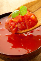 raw tomato pulp with basil over the spoon