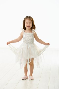 Laughing little girl in ballet costume