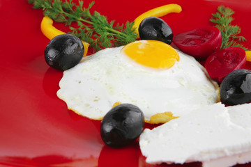 fried egg served on red dish