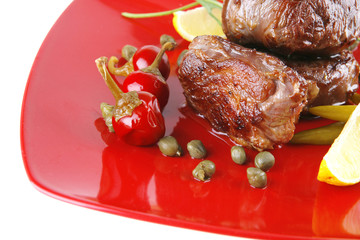 grilled meat medallion served on red
